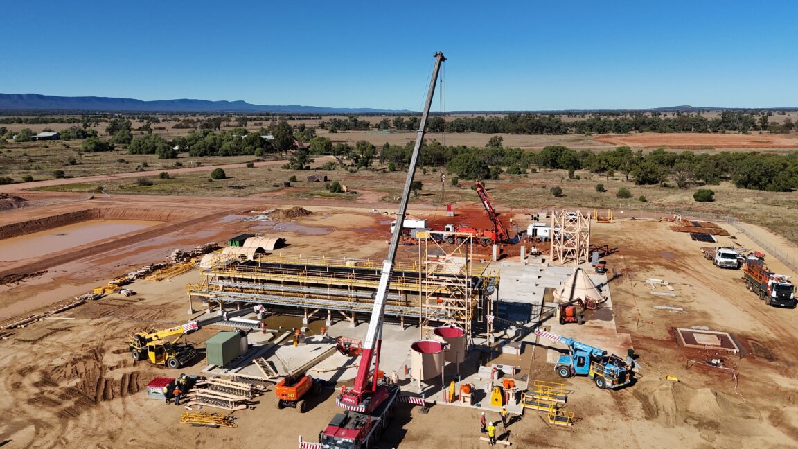 Large crane centered in a construction site