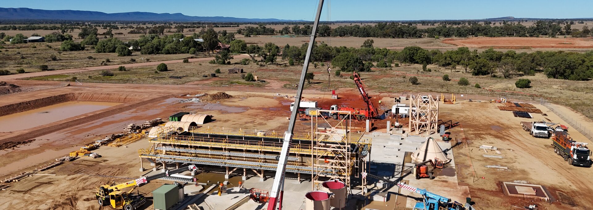 Large crane centered in a construction site