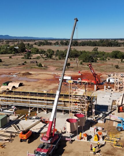 Large crane centered in a construction site