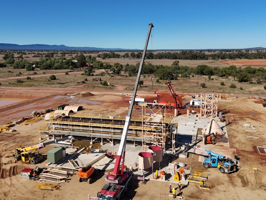 Large crane centered in a construction site