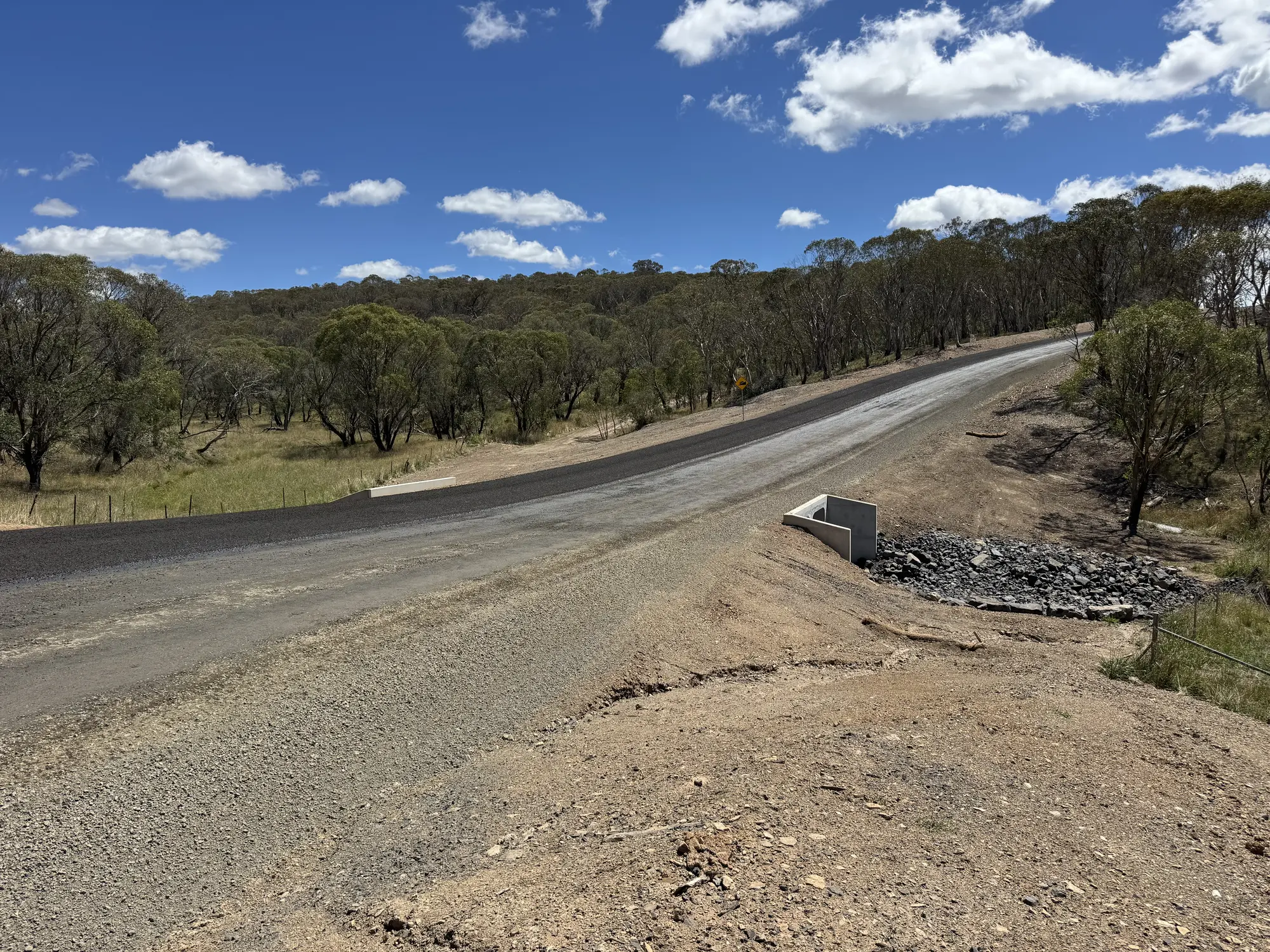 Completed Rockvale Road pavement beside an upgraded culvert outlet