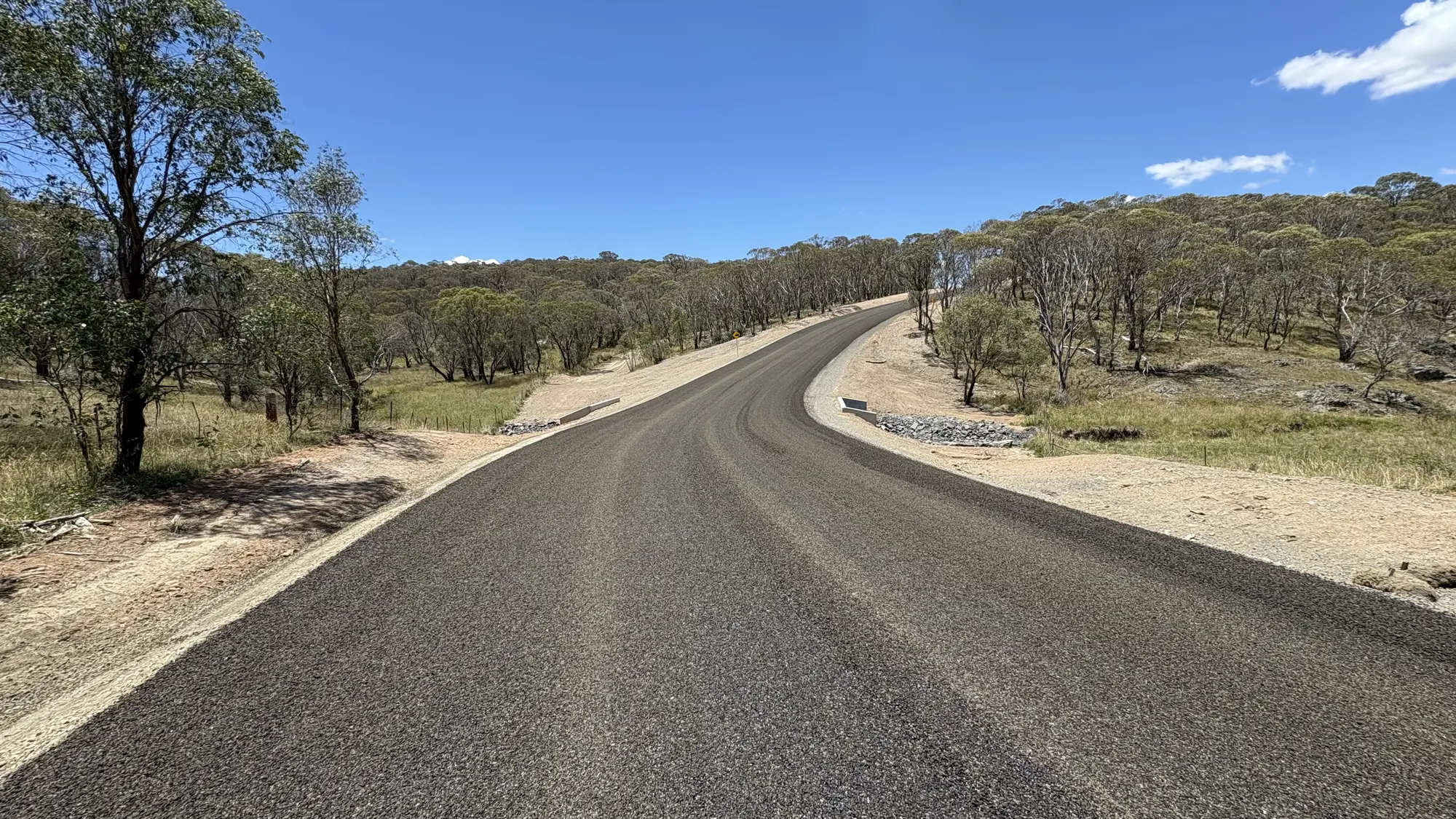 Completed Rockvale Road pavement winding through the surrounding bushland